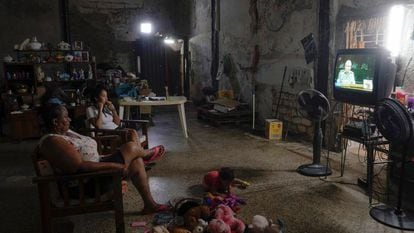 A family watches the news of the 8th Congress of the Communist Party of Cuba.