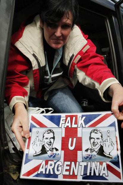 A Falklands resident shows off a sign that she placed in her car window last Thursday.