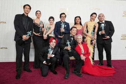 Harry Shum Jr., from back left, Jenny Slate, Tallie Medel, Ke Huy Quan, Stephanie Hsu, Michelle Yeoh, Brian Le, Andy Le, from front left, James Hong, and Jamie Lee Curtis pose with the award for outstanding performance by a cast in a motion pictures for "Everything Everywhere All at Once," in the press room at the 29th annual Screen Actors Guild Awards on Sunday, Feb. 26, 2023, at the Fairmont Century Plaza in Los Angeles.