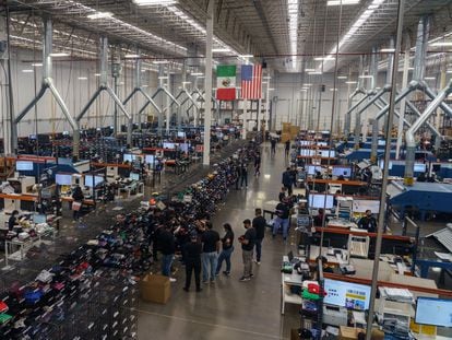 Workers design and print t-shirts at the TSC Miami factory in Ciudad Juárez, Mexico, December 1, 2021.