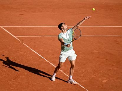 Carlos Alcaraz serves during a match on court Philippe Chatrier at Roland Garros.