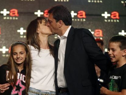Sergio Massa, mayor of Tigre near Buenos Aires, kisses his wife Malena next to their children after the results of Sunday&#039;s legislative elections were announced.