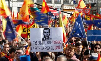 A protester holds a sign against caretaker prime minister, Pedro Sanchez, during the rally at Puerta del Sol in Madrid.