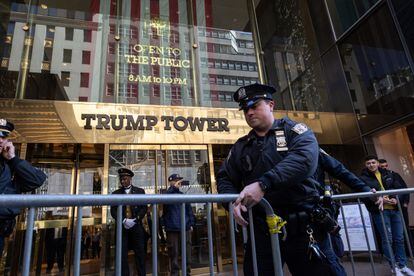 Members of the NYPD install barricades in front of Trump Tower.