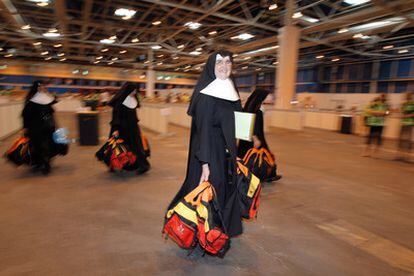 A group of nuns carry backpacks that will be distributed among the pilgrims.