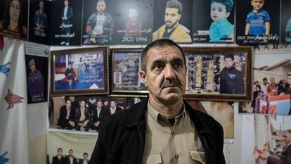 Mustafa Mina Nabi with photos of his son and other Kurdish-Iraqi migrants who drowned in the English Channel in 2021; Ranya (Iraqi Kurdistan); November 2022.