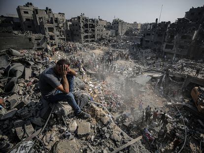 A man observes rescue efforts in the Jabalia refugee camp, on the outskirts of Gaza City, on Wednesday November 1.