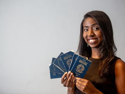 Brazilian traveler Nataly Castro with the passports she used to travel to over 180 countries and territories.