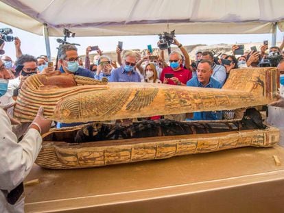 Egyptologists opening a sarcophagus at the necropolis of Sakkara, Egypt, in October 2020.