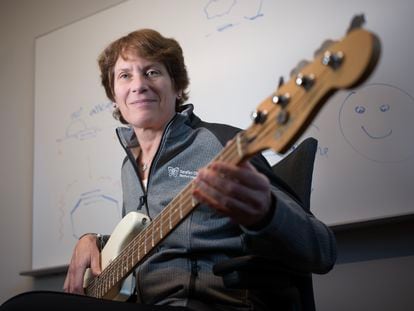 Chemist Carolyn Bertozzi poses with the bass she keeps in her lab at Stanford University.