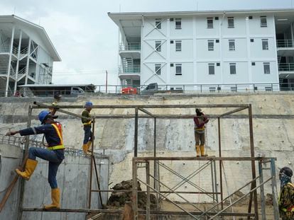 Workers build a metal structure at the construction site of the new capital city in Penajam Paser Utara, East Kalimantan, Indonesia, Wednesday, March 8, 2023.