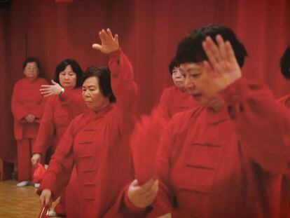 A group of Chinese seniors practices a traditional dance in the cultural center of Chinese New Year.