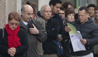 Jobseekers wait in line outside a Madrid unemployment office.