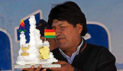 Evo Morales holds a present from a worker at a lithium plant.