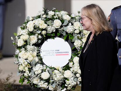 Amy Carter walks past a wreath honoring her mother during a wreath laying ceremony at the Rosalynn Carter Health & Human Services complex on the campus of Georgia Southwestern State University in Americus, Georgia, Nov. 27, 2023.