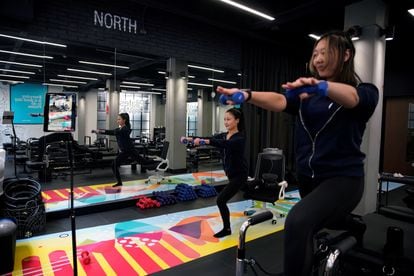 Two Pilates instructors practice exercises in their studio in Shanghai, China.