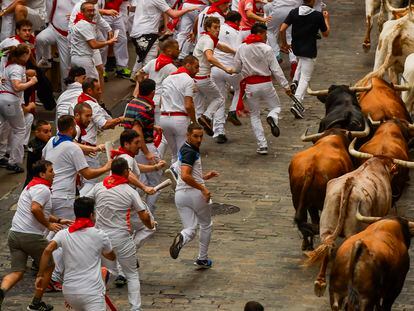 La Palmosilla's fighting bulls among runners during the first day of the running of the bulls during the San Fermin fiestas in Pamplona on July 7, 2023.
