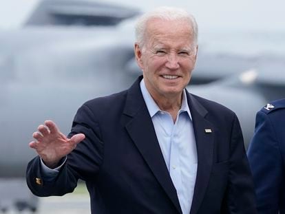 President Joe Biden waves to members of the media as he walks to board Air Force One at Dover Air Force Base in Delaware, Sunday, July 9, 2023.