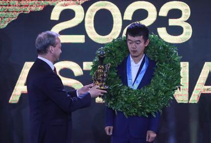 International Chess Federation President Arkady Dvorkovich (l) hands Chinese grandmaster Ding Liren the trophy during the closing ceremony of the FIDE Chess World Championship 2023 in Astana, Kazakhstan.