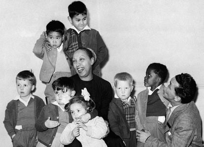 Joséphine Baker and her husband, Joe Bouillon, pose with seven of their 12 adopted children. Jean-Claude is the first from the left.
