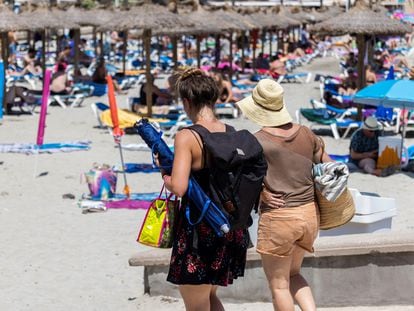 Tourists on Peguera beach, in the city of Calvià on the island of Mallorca.
