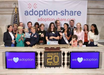 In this photo provided by the New York Stock Exchange, Adoption-Share founder and CEO Thea Ramirez, center, Miss Utah USA 2013 Marissa Powell, center right, and fellow adoption supporters ring the opening bell at the New York Stock Exchange in New York on Aug. 20, 2013