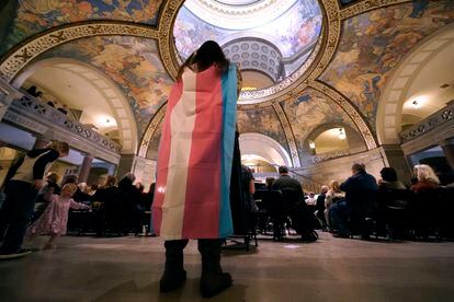 Glenda Starke wears a transgender flag as a counter protest during a rally in favor of a ban on gender-affirming health care legislation