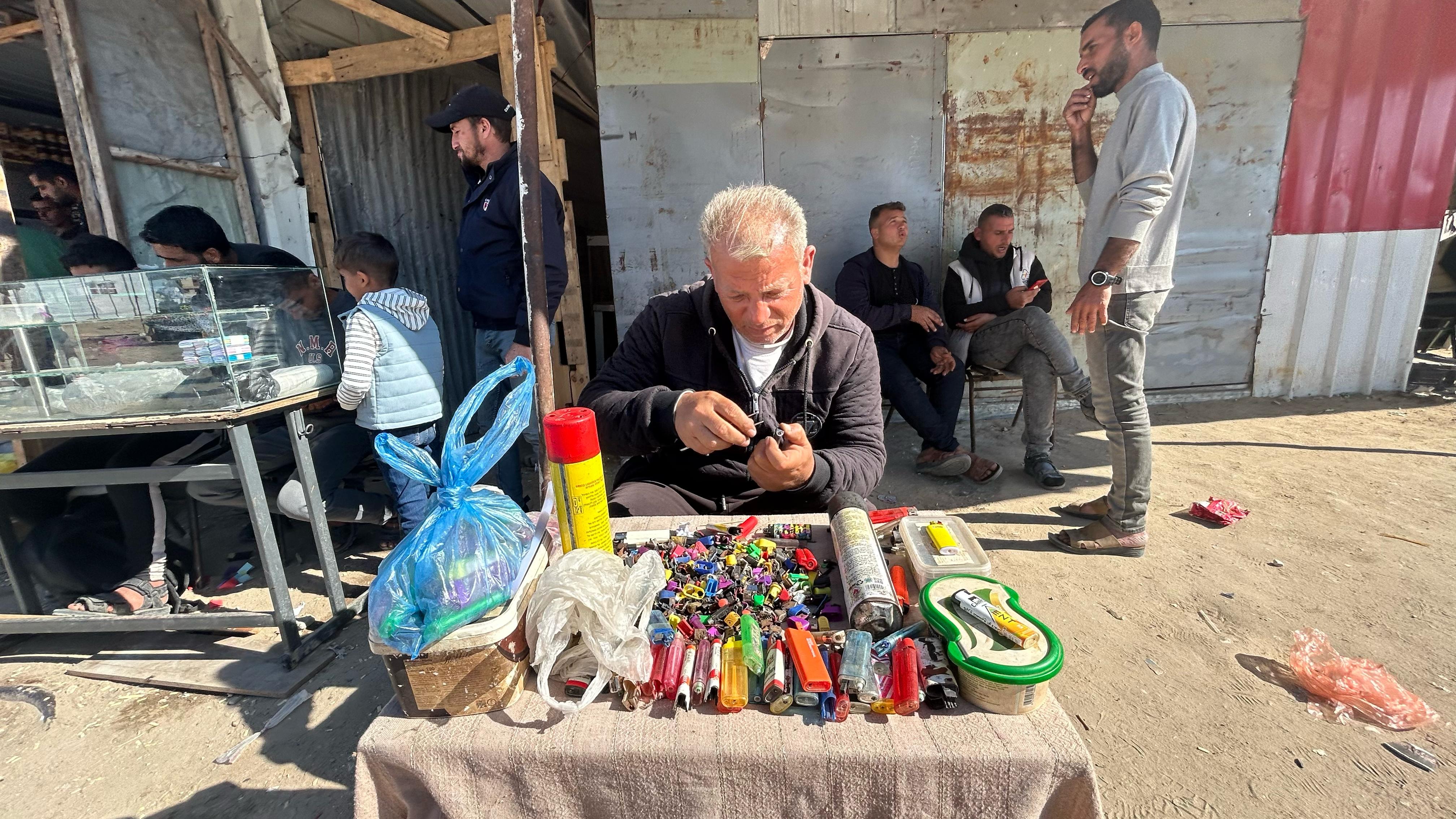 Wael Barbakh, 50, uses pieces from broken lighters to repair ones that no longer work, in Khan Younis, Gaza, April 15.