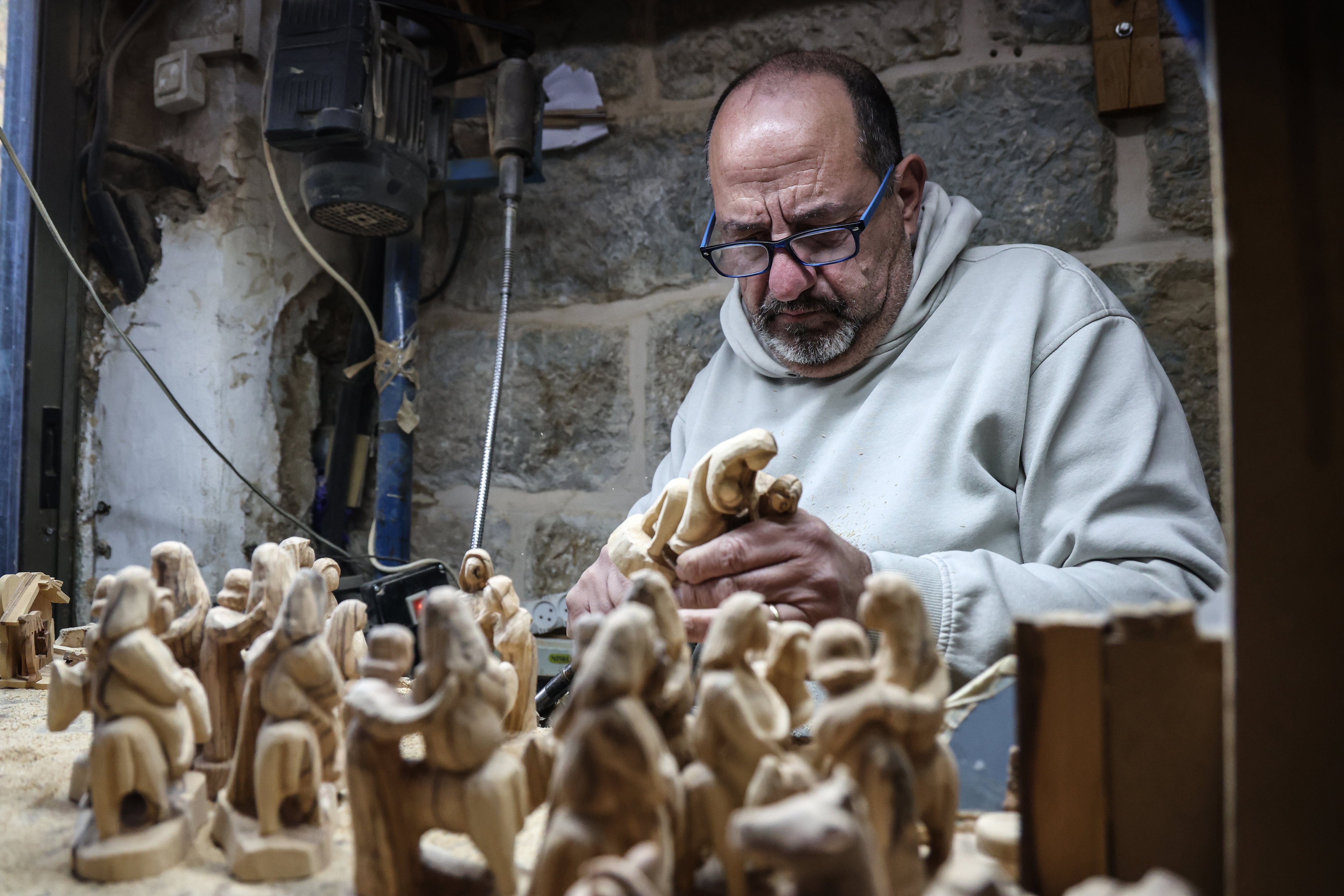 Jack Giacaman carves olive wood in his workshop last Wednesday in Bethlehem.