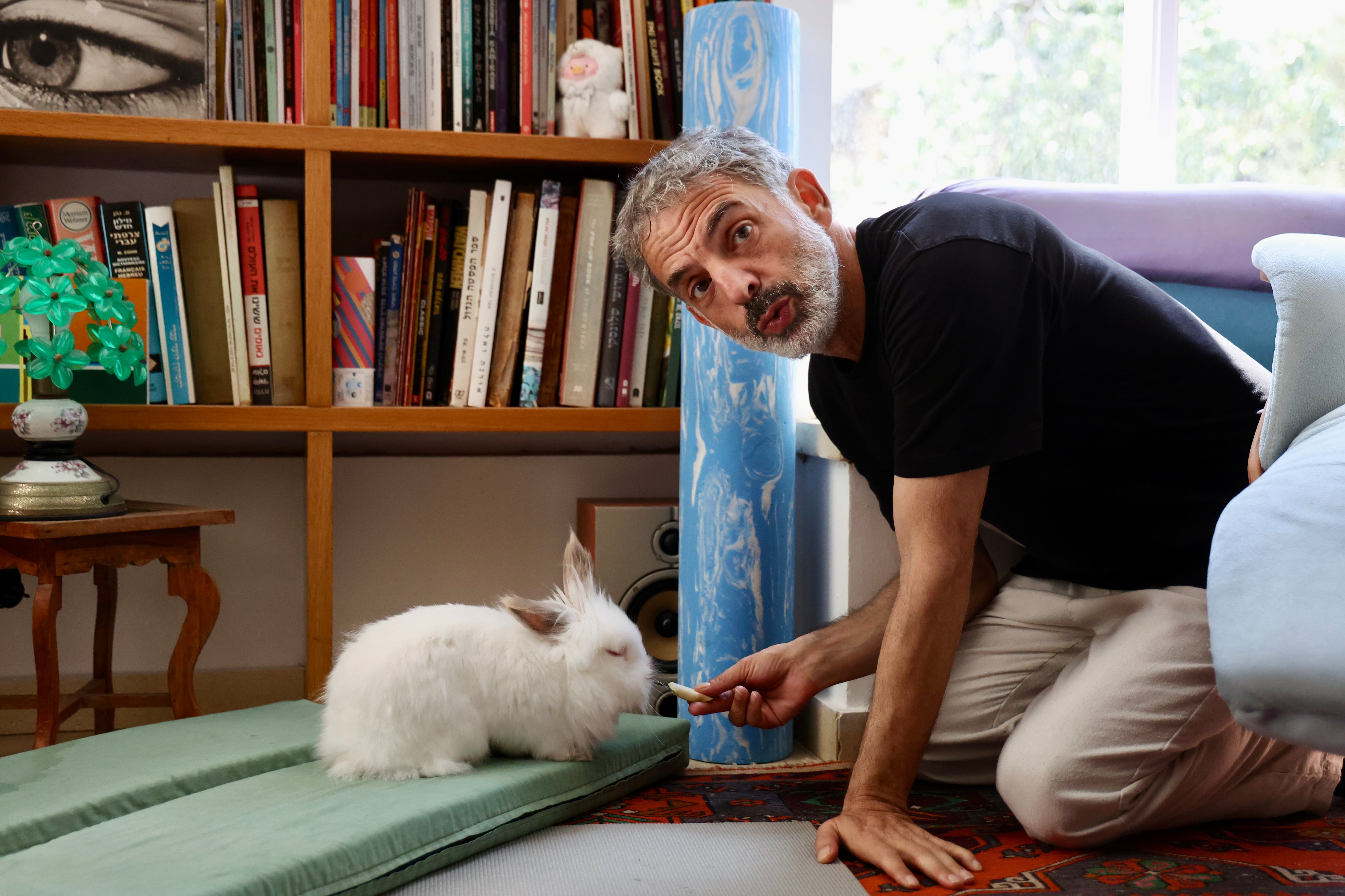 Etgar Keret poses with his rabbit before the interview, at his home in Tel Aviv.