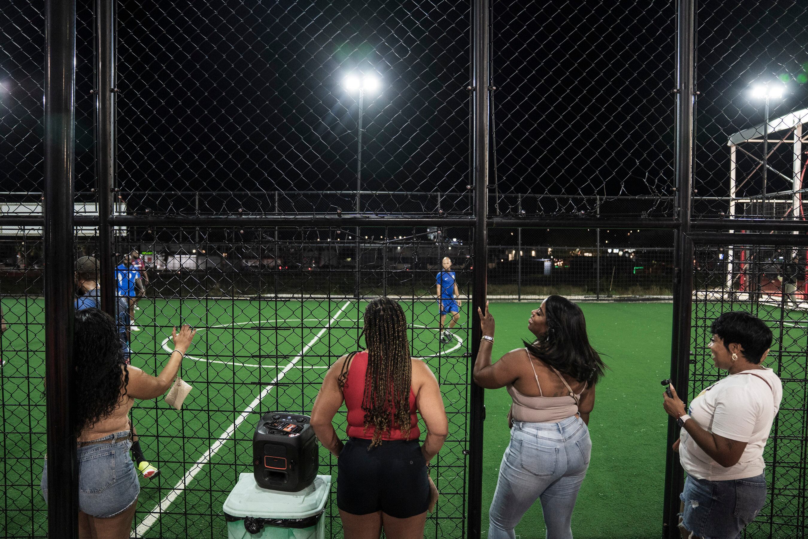 Spectators listen to music during an amateur match.