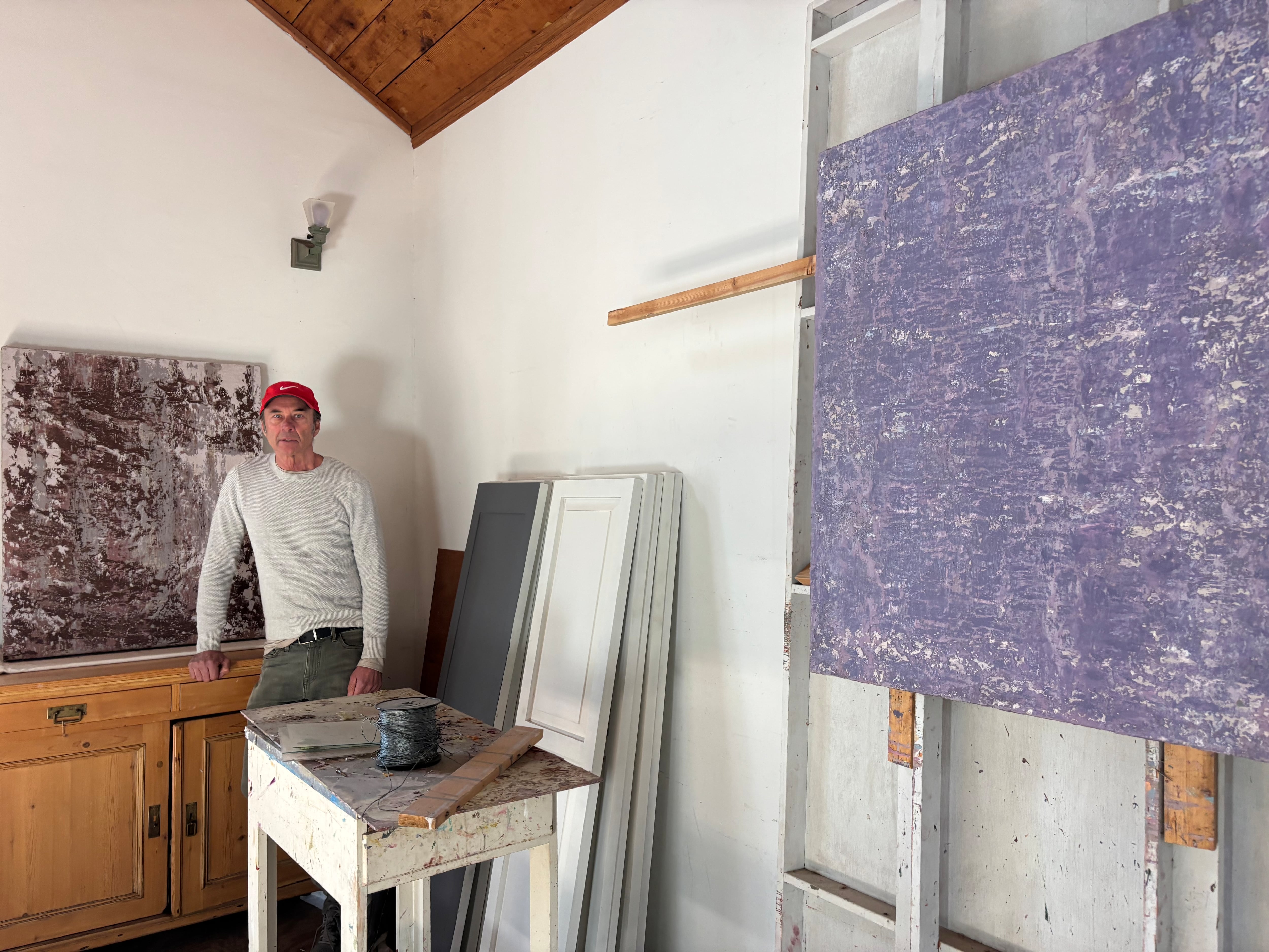 Gregory Dane, with the paintings for which he draws inspiration from the Eaton Canyon, a source of the fire that devastated parts of  Altadena, on January 15, 2025.