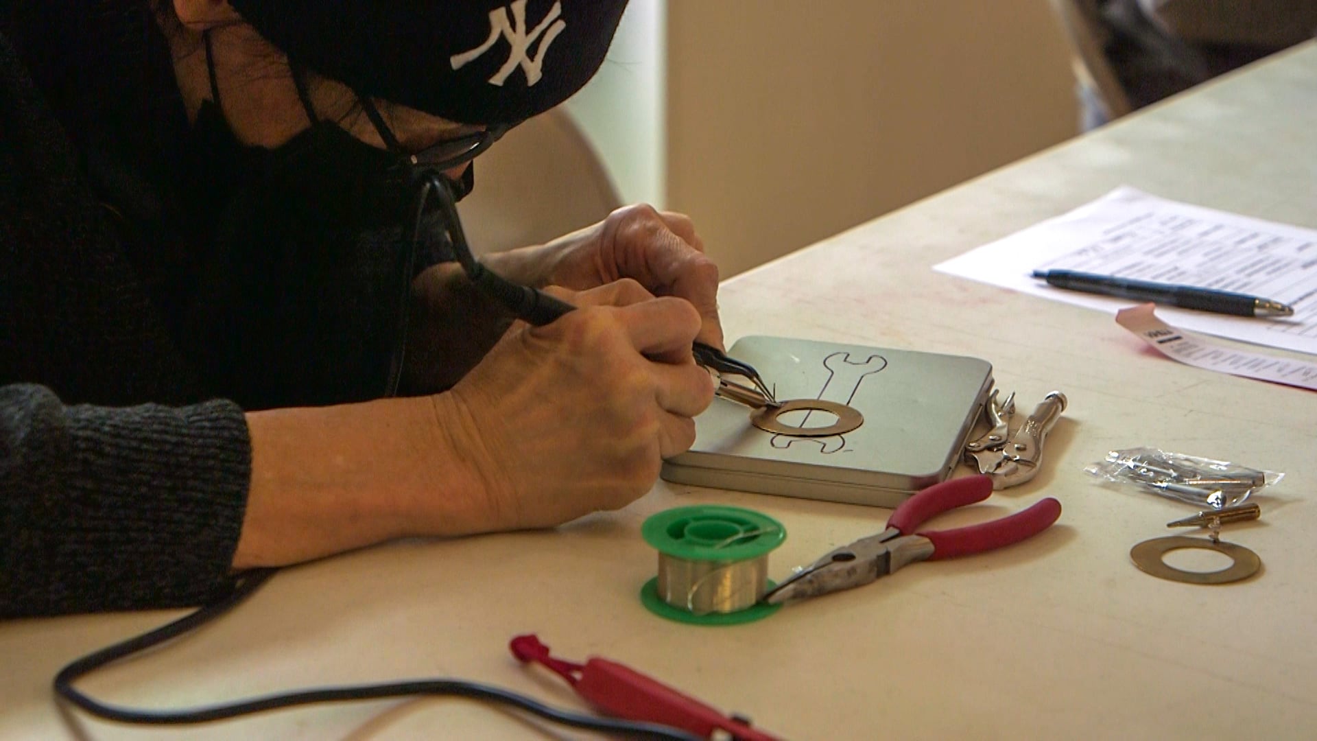 Kenneth Mah does repair work at the New York workshop.