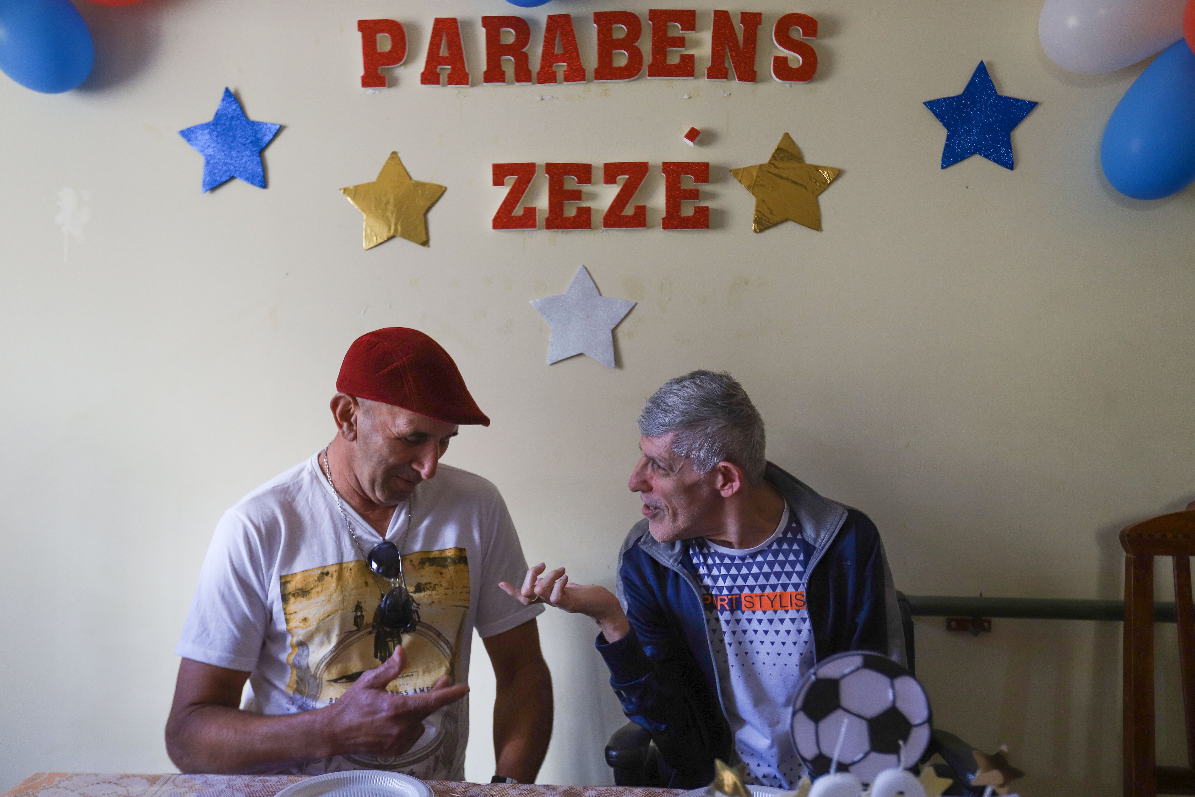 Two survivors, Bento Marcio da Silva and Zezé, celebrate the latter’s birthday in 2021 at the therapeutic residence where they were placed.