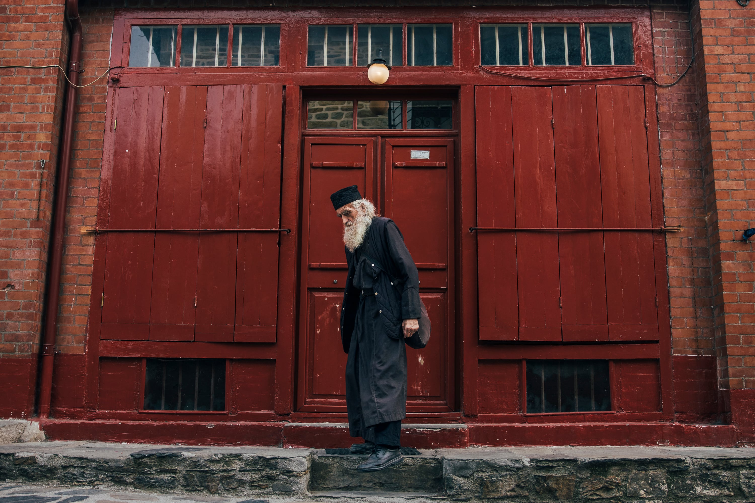 A monk walks along the only street with shops in the center of Karyes, the administrative capital of the Monastic State of Mount Athos.