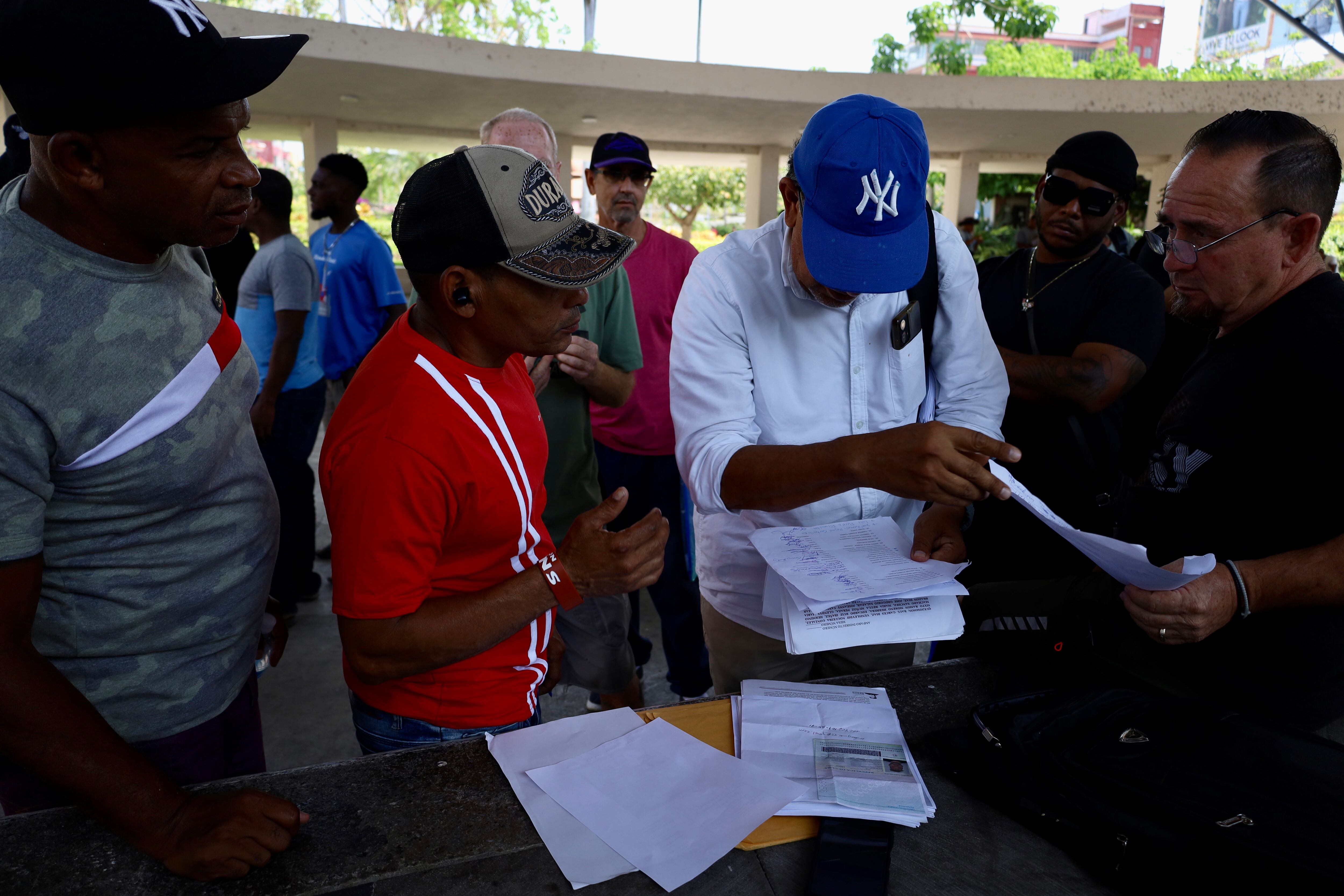 A group of Cubans deported to Mexico organize their documents in downtown Tapachula, Chiapas, on March 26.