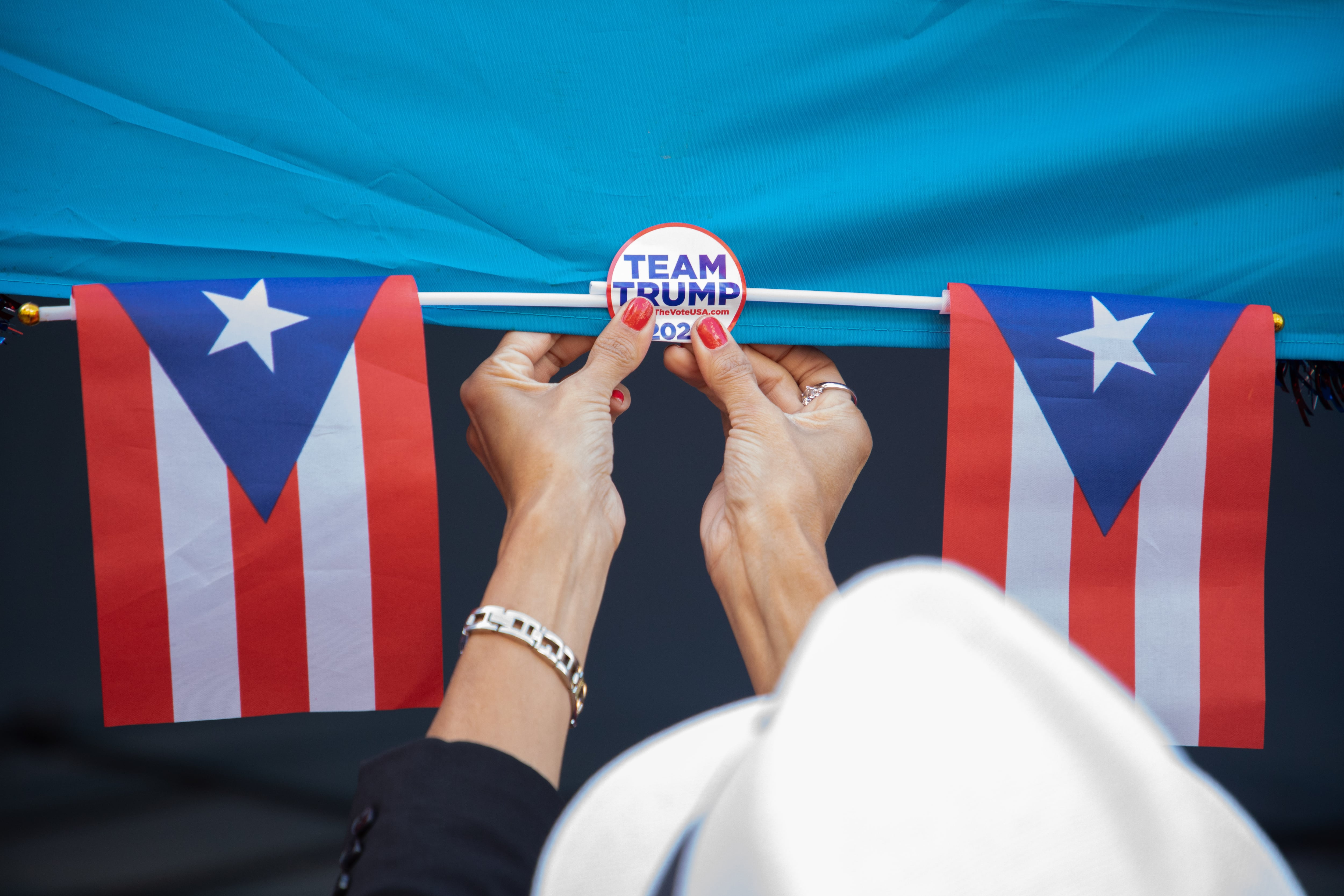 A Trump campaign volunteer places a pin of the Republican candidate next to Puerto Rican flags on Sept. 8 in Reading, Pennsylvania.