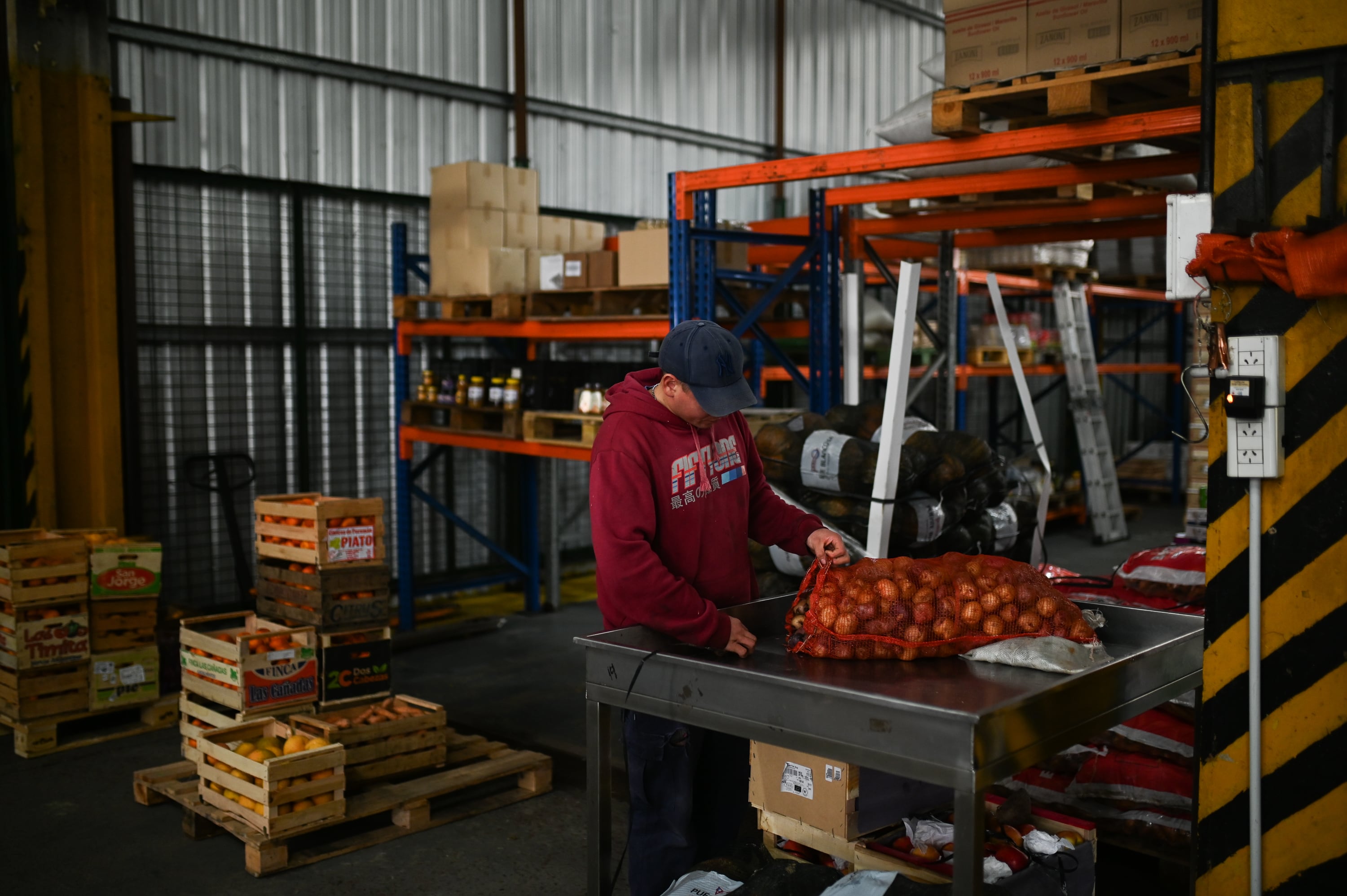 Franco Gabriel Gari, an employee for Alta Red, unpacks Andean papines andinos from Iruya at the Central Market in Buenos Aires on September 30.
