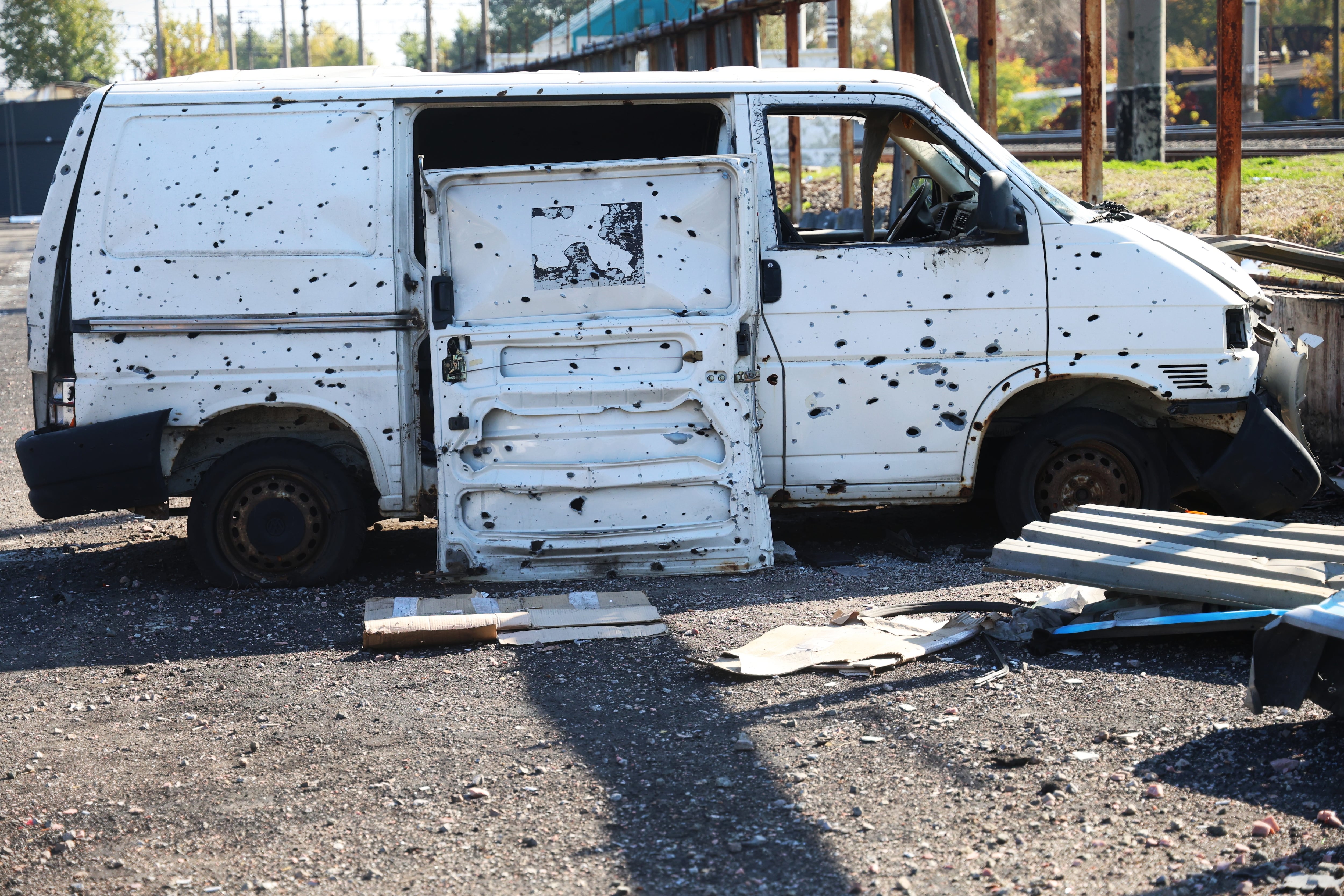 A van pockmarked by shrapnel from the shock wave following a missile strike on the Pochaina market in Kyiv.