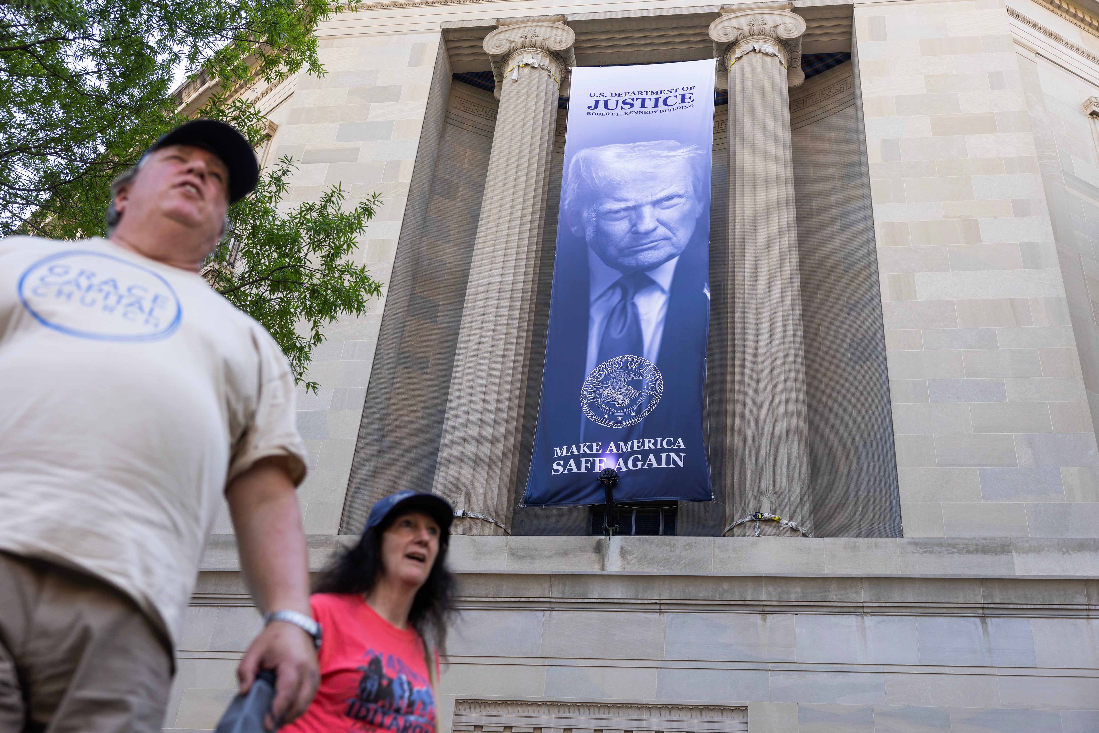 Banner bearing the president’s face unfurled over the Department of Justice.