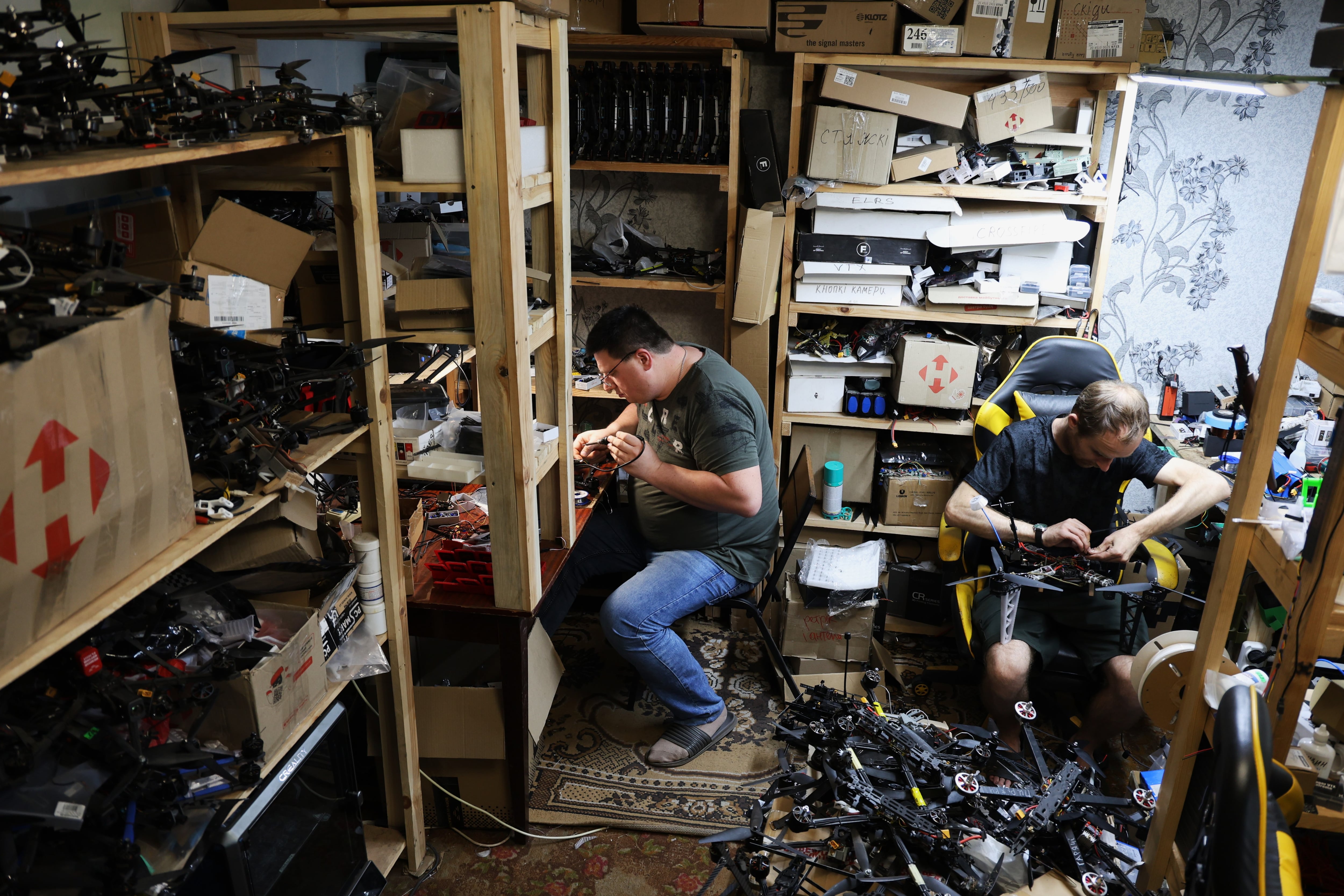 Vadim (left) and Serhii turn civilian drones into weapons near the Donetsk front on May 14.