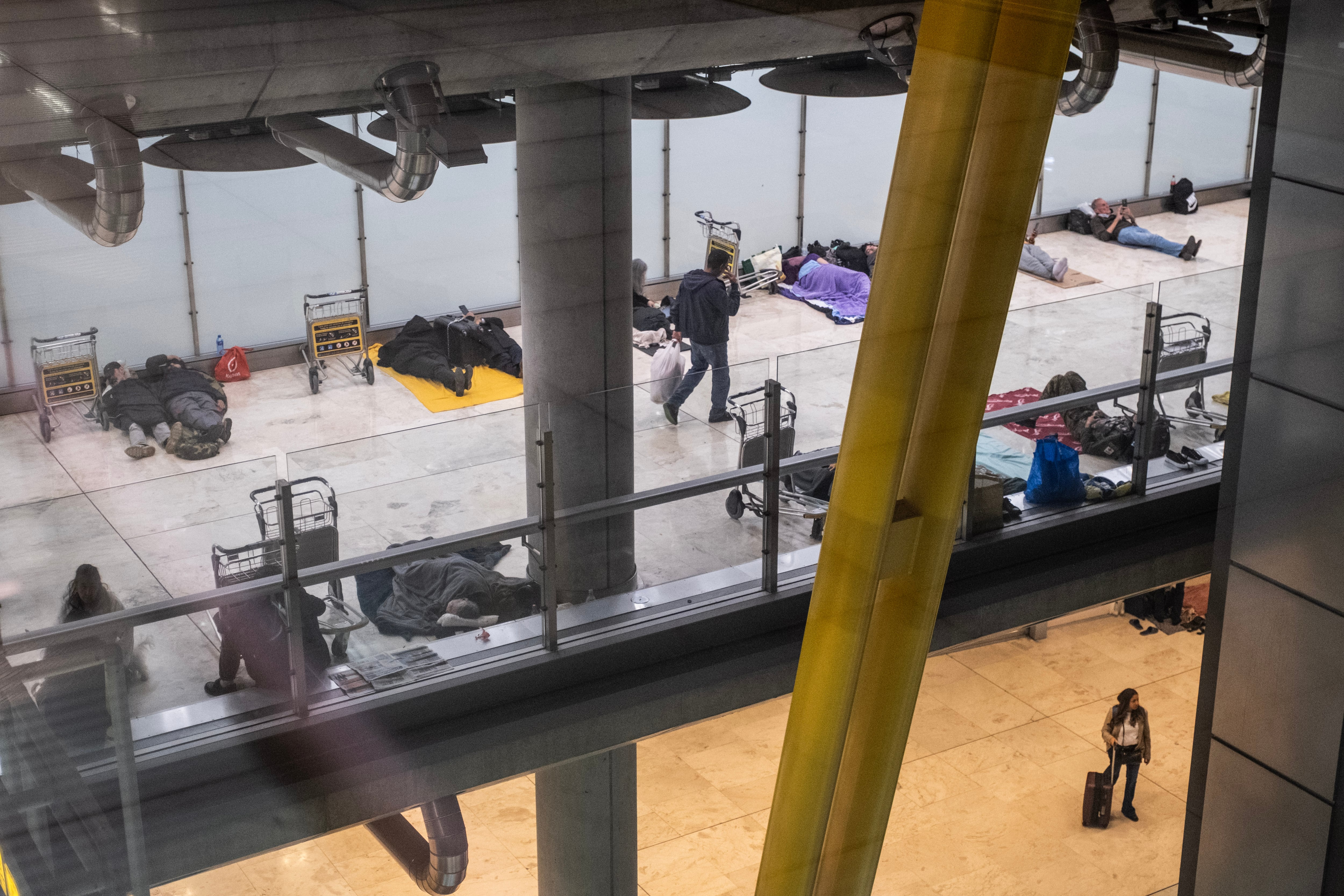 Homeless people sleeping at Madrid-Barajas airport on Monday.
