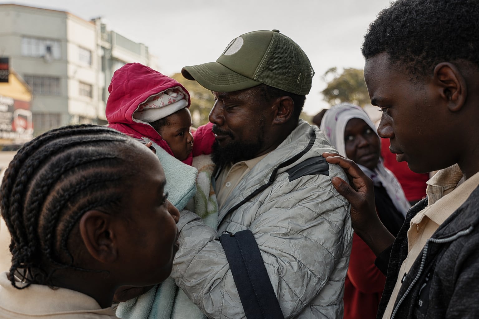 Kurda Mussa holds his daughter Priscilla as his other two children look on in Durban. 