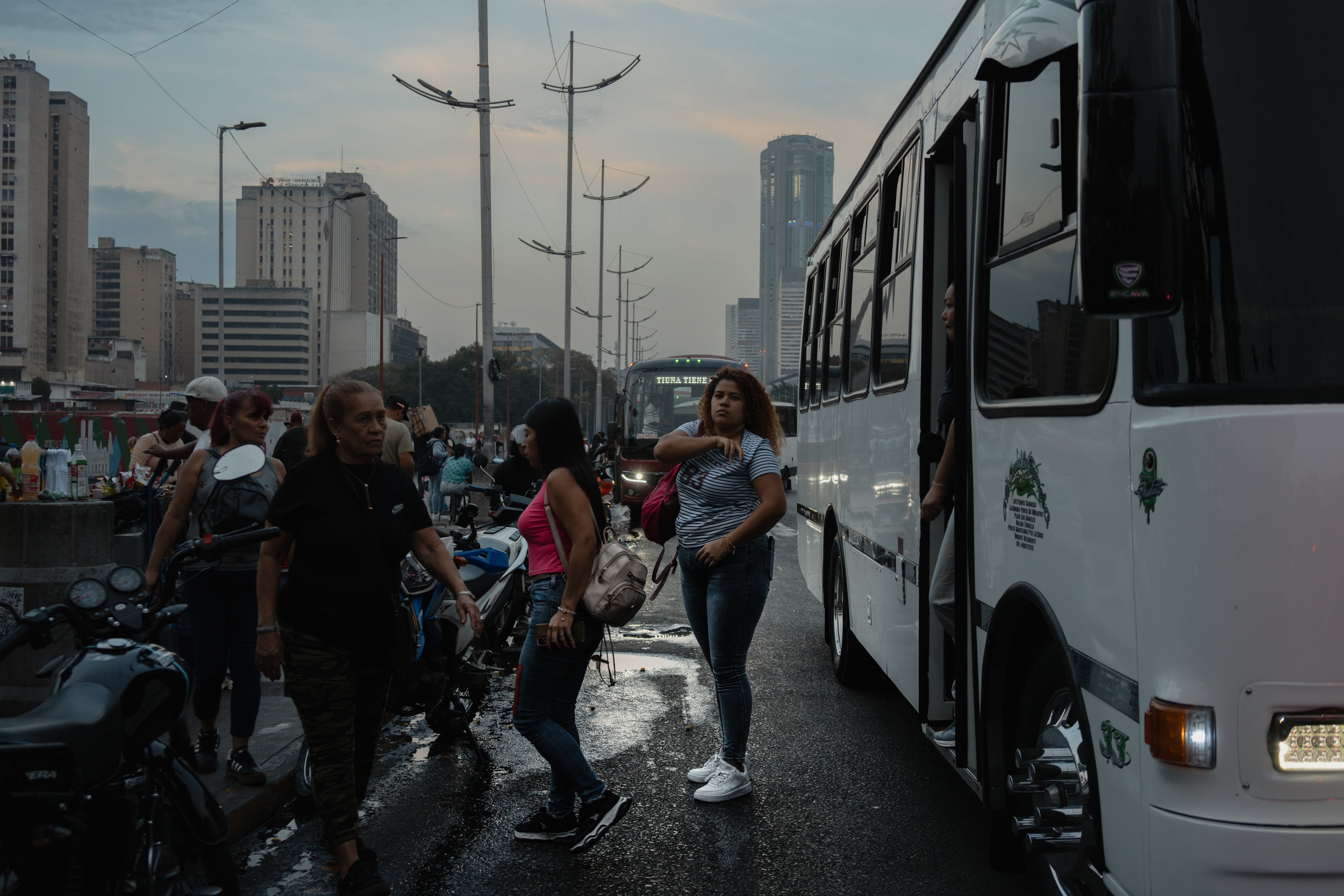 A woman gets off a bus in downtown Caracas.