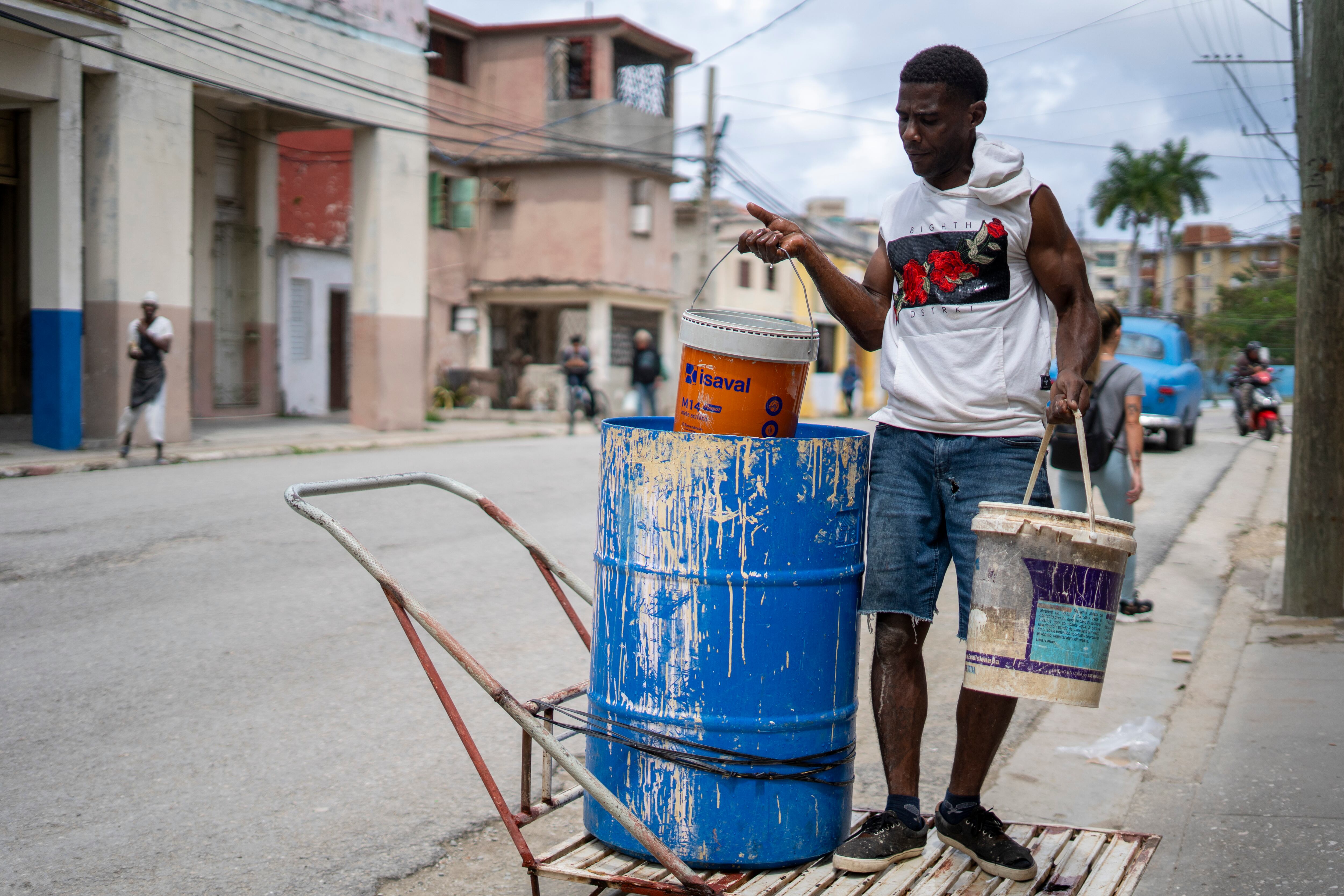 A man distributes water amid the shortage in the Cerro municipality in Havana.