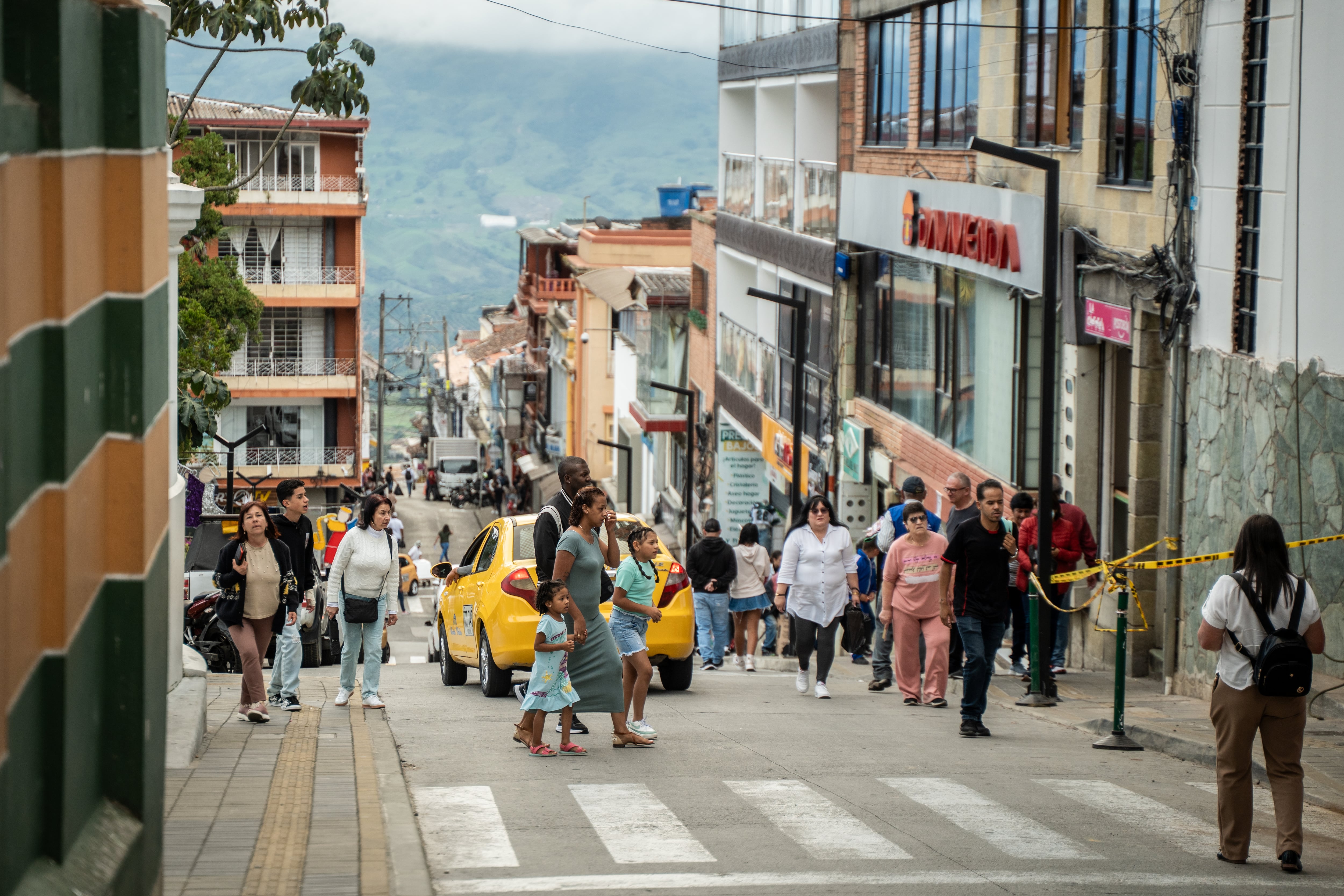 Residents walk through the town in Yarumal, Antioquia.
