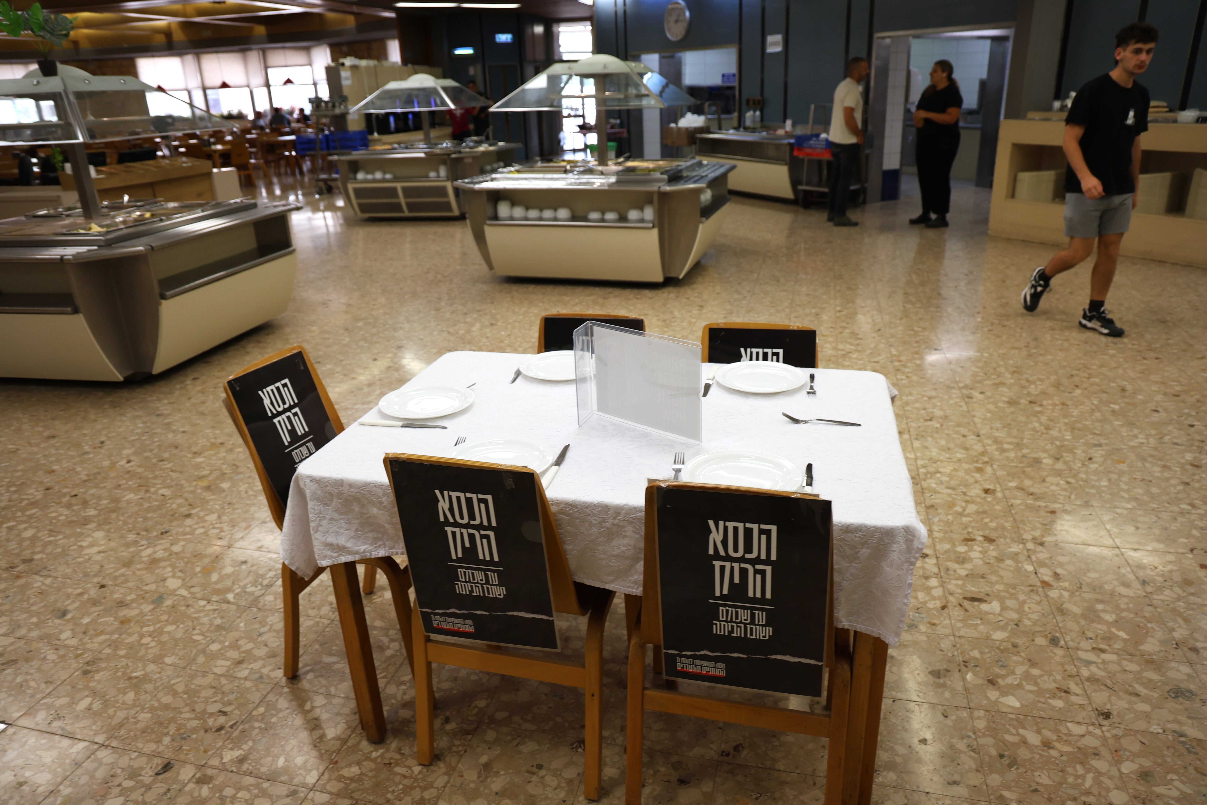 Table in memory of the five residents of Kibbutz Be'eri who were kidnapped and are presumed dead.