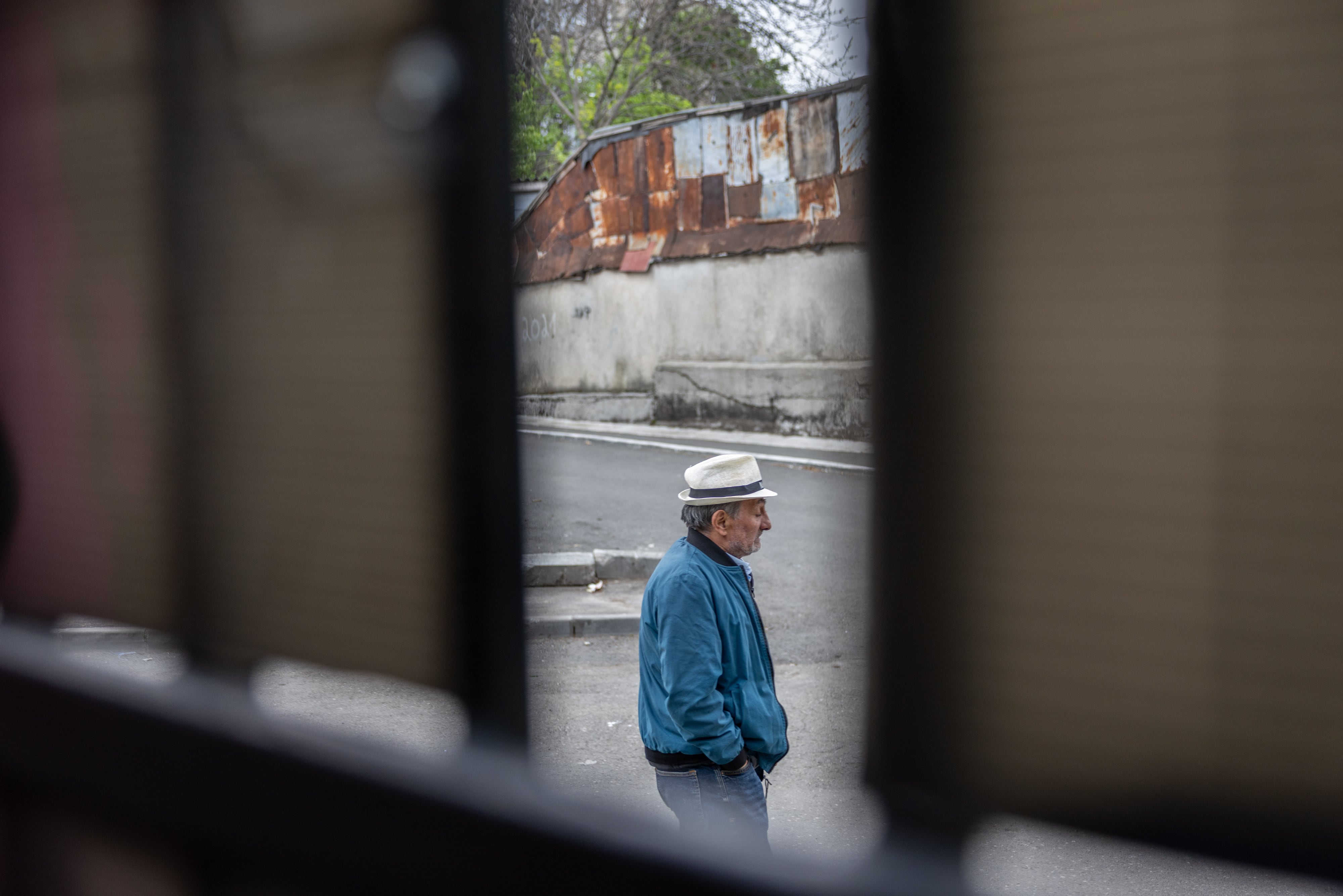 A man walks along a street in the Ferentari neighborhood of Bucharest. It is one of the poorest areas of the Romanian capital, populated mainly by Roma.
