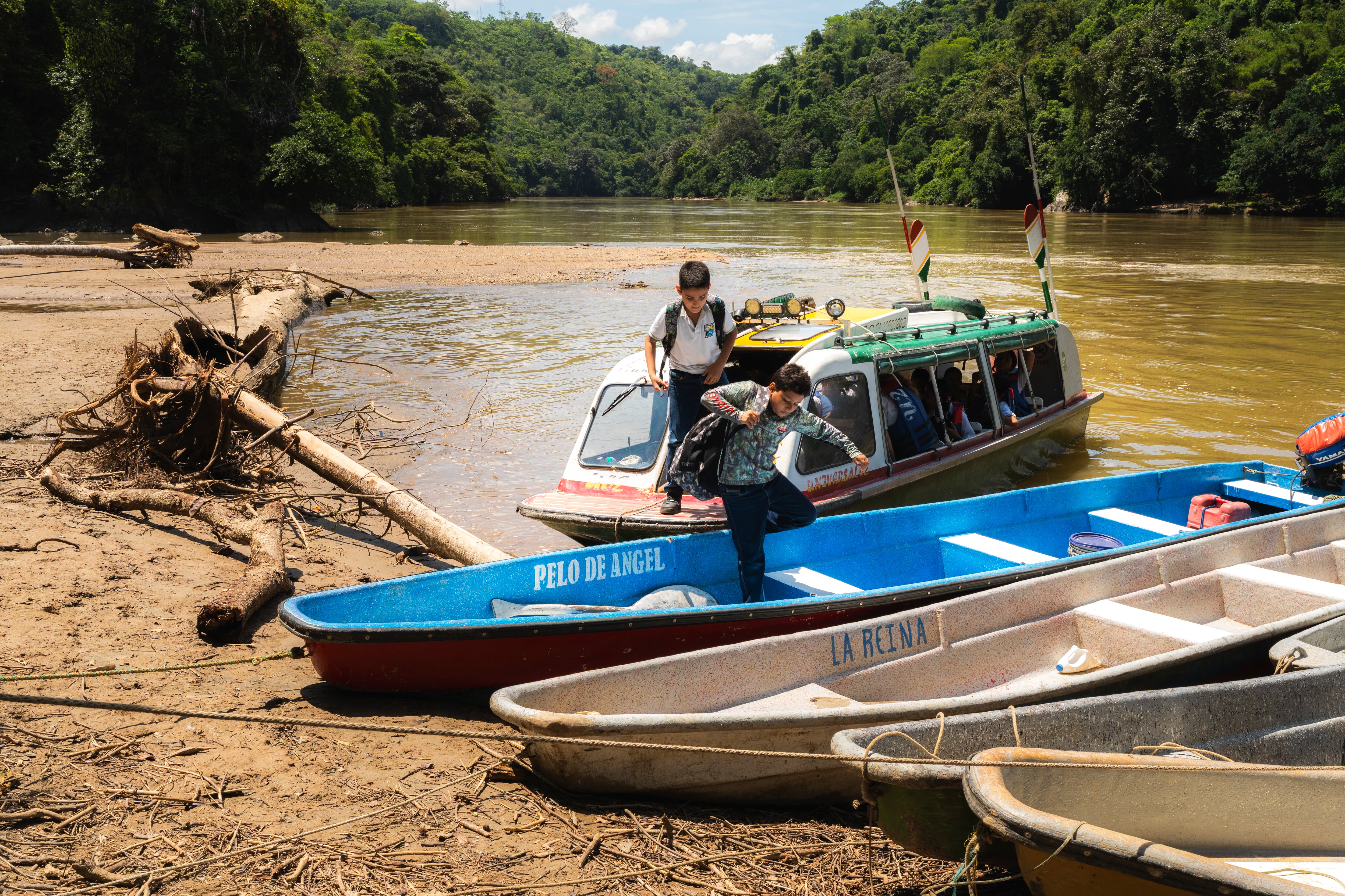 Luis Ángel Arango and Luis Felipe Pérez walk to their home on the Samana River.