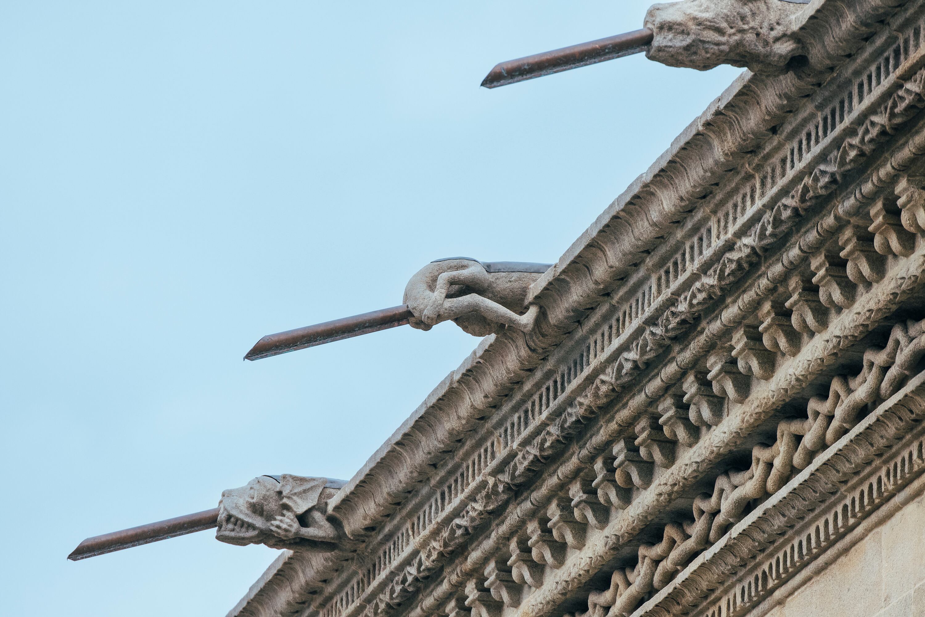 Three of the eight gargoyles on the right half of the façade, including the anthropomorphic one that became the focal point of the controversy.

